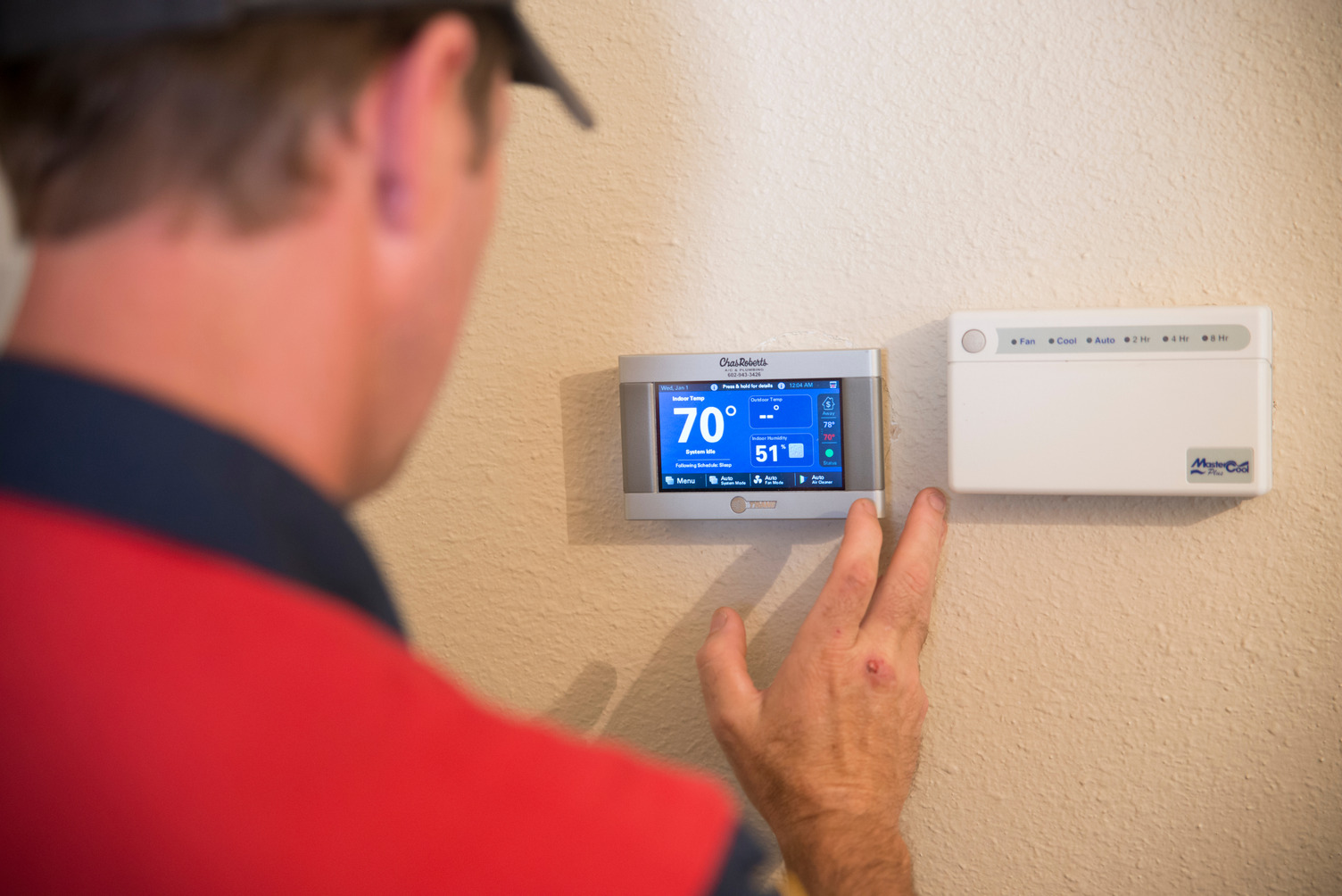 Man working on AC panel