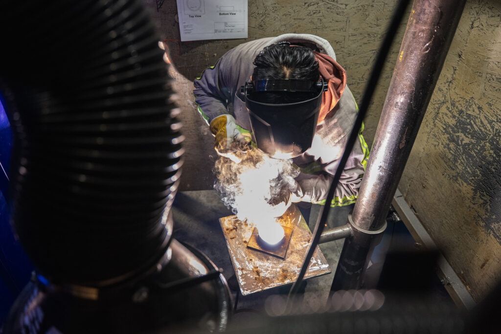 Welder using tools in training